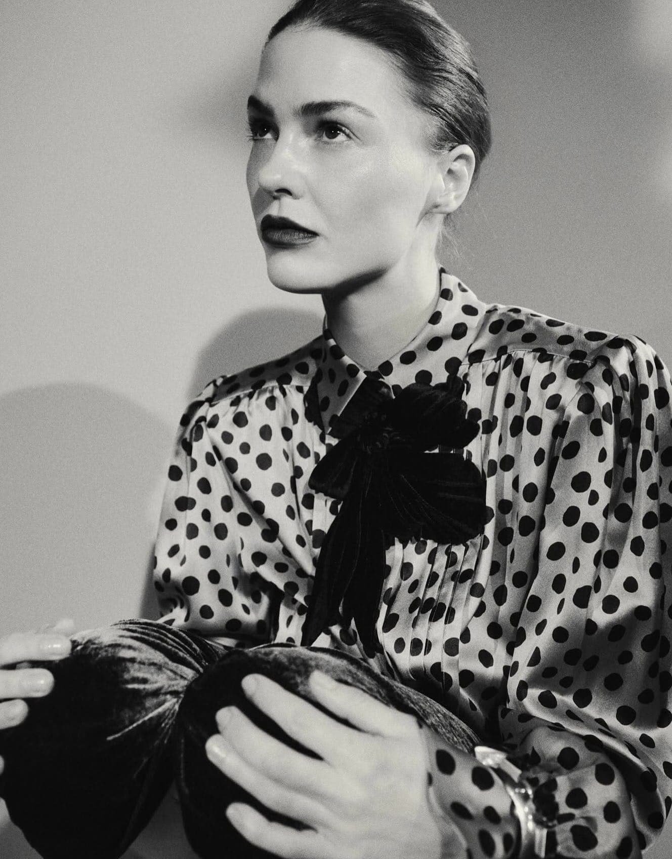 Portrait of a person in a polka-dot blouse